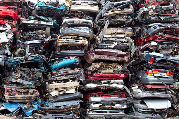 Stacked crushed cars going to be shredded in a recycling facility